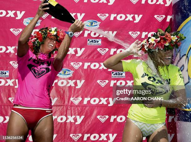 Newly crowned Roxy Pro champion Layne Beachley of Australia sprays champagne on her compatriot and runner-up Trudy Todd as they celebrate their...