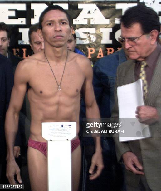 Adonis Rivas, flyweight world champion , is weighed at the Luna Park in Buenos Aires, 12 July 2002. Rivas who weighed in at 50,600 kg, will face...