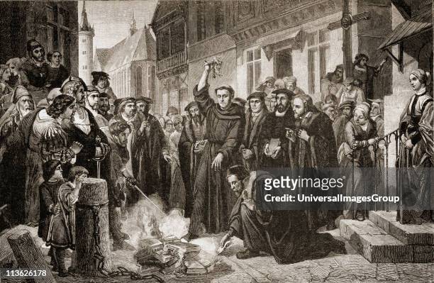 Martin Luther burning the Papal Bull along with the book of church law and many other books by his enemies on December 10, 1520 in Wittenberg where...