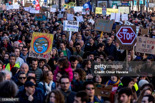Protesters march holding signs on climate change during the Marche Du Siecle on March 16, 2019 in Paris, France. According to organizers, more than...