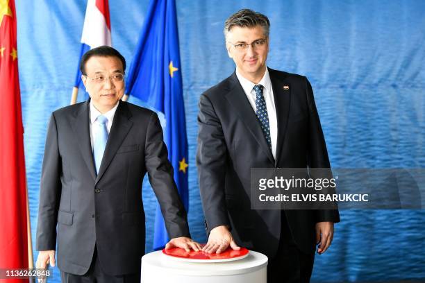 Prime minister of People's Republic of China, Li Keqiang and his Croatian counterpart, Andrej Plenkovic , pose as they push the "red button", on...