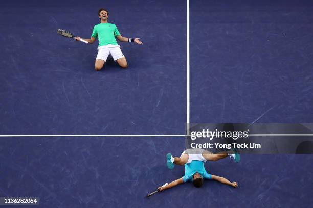 Nikola Mektic of Croatia and Horacio Zeballos of Argentina celebrate their men's doubles final match victory against Lukasz Kubot of Poland and...