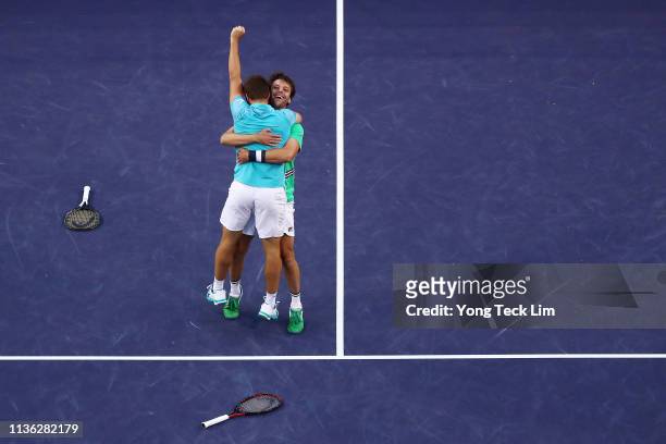 Nikola Mektic of Croatia and Horacio Zeballos of Argentina celebrate their men's doubles final match victory against Lukasz Kubot of Poland and...