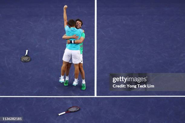 Nikola Mektic of Croatia and Horacio Zeballos of Argentina celebrate their men's doubles final match victory against Lukasz Kubot of Poland and...