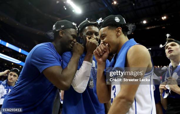 Teammates Zion Williamson, RJ Barrett, and Tre Jones of the Duke Blue Devils react after defeating the Florida State Seminoles 73-63 in the...