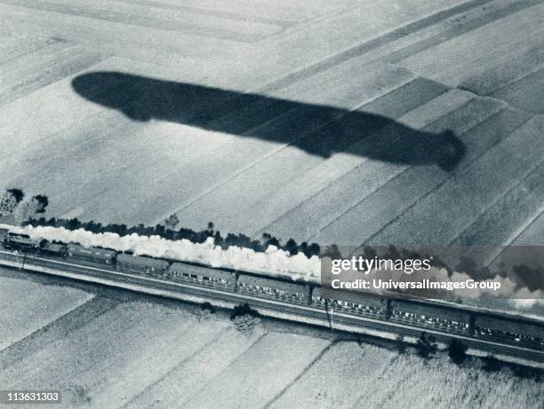 Shadow of the fast Zeppelin air ship Schwaben keeping pace with an express train. From The Illustrated War News, 1915.