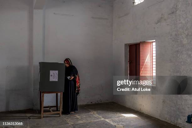 An Indian Muslim woman votes at a polling station on April 11, 2019 in Muzzafarnagar, Utter Pradesh, India. Indians voted in the first phase of...