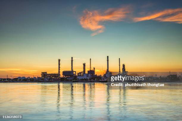 oil refinery and petrochemical plant at sunrise.- oil and gas industry. - gas plant sunset stock-fotos und bilder