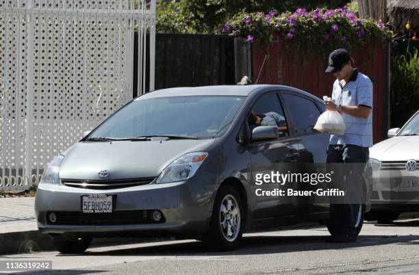 Leonardo DiCaprio picks up food at Cha Cha Chicken on July 01, 2004 in Los Angeles, California.