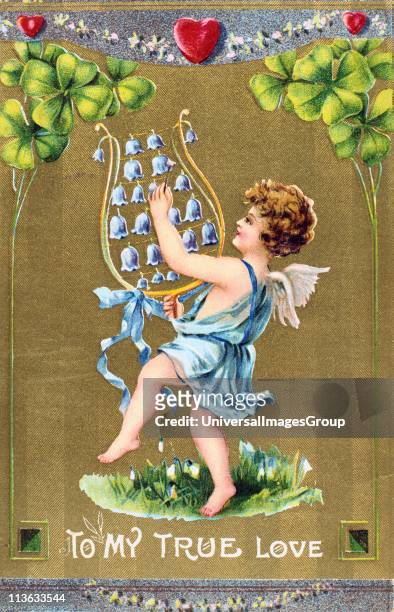 To My True Love, c1910. American Valentine card. Cupid dances on grass with naturalised Snowdrops and is playing a lyre of Bluebells. Above him are...