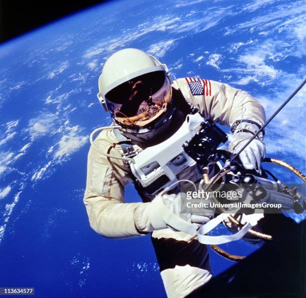 Astronaut Edward H White II carrying out external tasks during third orbit of Gemini-Titan 4 flight. NASA photograph.