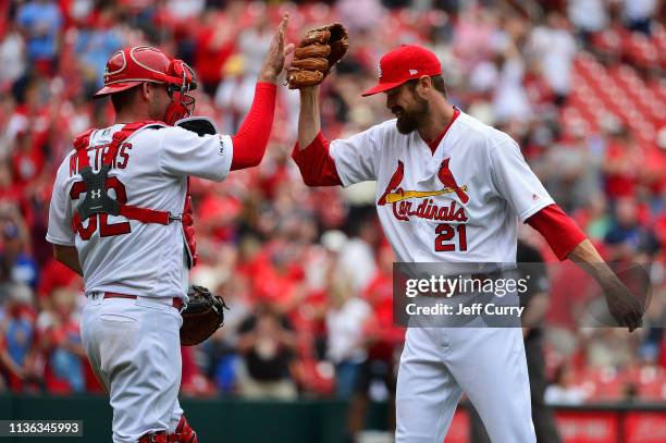 Andrew Miller of the St. Louis Cardinals celebrates with Matt Wieters after the Cardinals swept the Los Angeles Dodgers at Busch Stadium on April 11,...