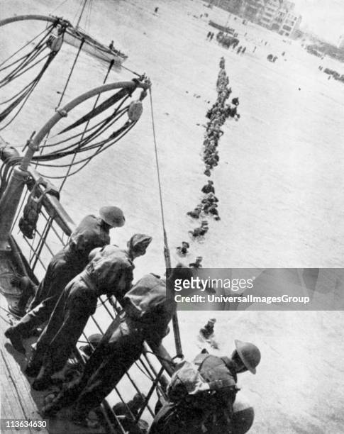World War 2: British retreat from Dunkirk. British troops wading out to board small boats which ferried them to larger vessels for transport back to...