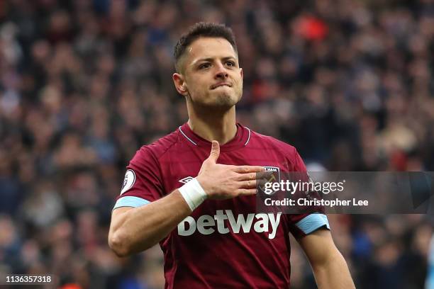 Javier Hernandez of West Ham United celebrates their third goal by touching the club crest during the Premier League match between West Ham United...