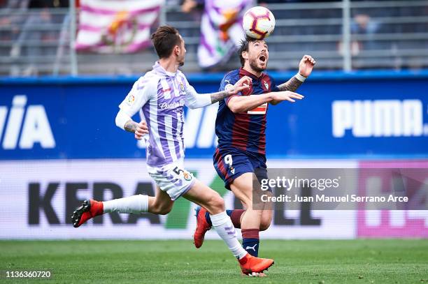Miguel Herrero of Real Valladolid CF competes for the ball with Sergi Enrich of SD Eibar during the La Liga match between SD Eibar and Real...