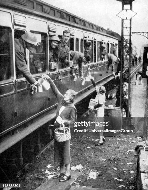 Local residents supplying refreshments to trainload of British soldiers who had been withdrawn from the beaches of Dunkirk on 3-4 June 1940 and...