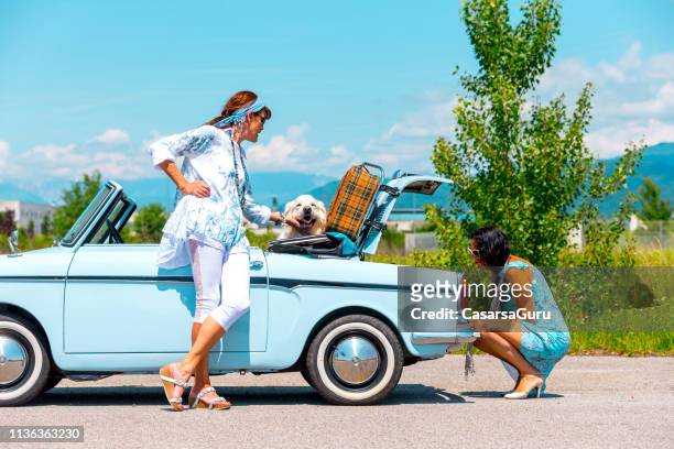 mature couple on a road trip fixing a broken vintage car - car boken stock pictures, royalty-free photos & images