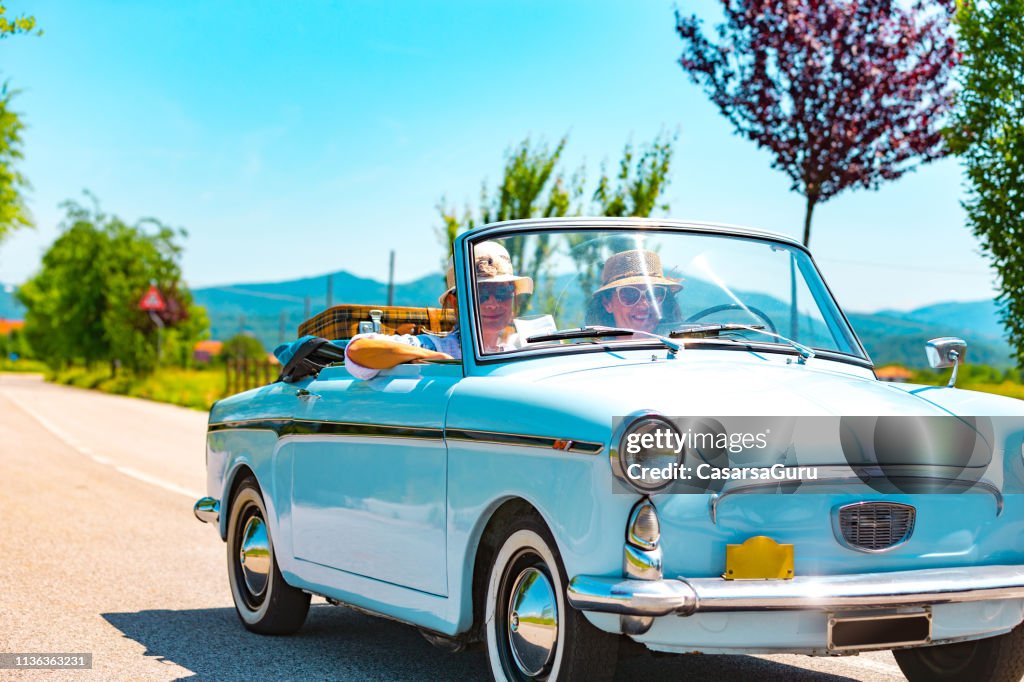 Mature Couple on a Road trip with a Vintage car