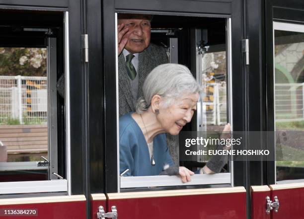 Japan's Empress Michiko and Emperor Akihito wave to well-wishers as they visit Kodomonokuni, or Children's Land, to mark the 60th anniversary of...