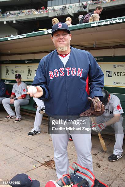 Bobby Jenks of the Boston Red Sox hangs out in the dugout before the game against the Oakland Athletics at the Oakland-Alameda County Coliseum on...