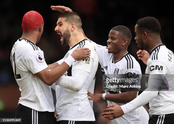 Ryan Babel of Fulham celebrates with Aleksandar Mitrovic of Fulham after he scores his sides first goal during the Premier League match between...