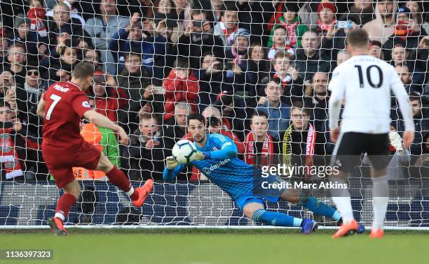 James Milner of Liverpool scores his sides second goal from the penalty spot past Sergio Rico of Fulham during the Premier League match between...