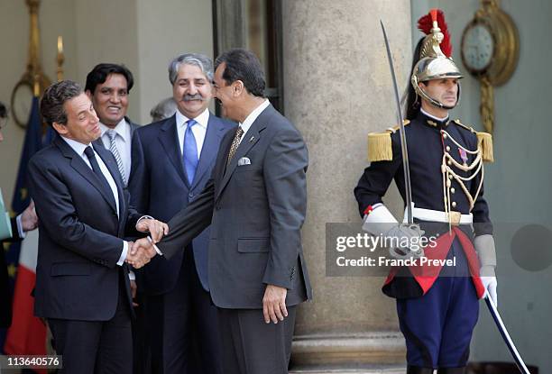 French President Nicolas Sarkozy shakes hand with Pakistan's Prime Minister Yousuf Raza Gilani after a meeting at Elysee Palace on May 4, 2011 in...