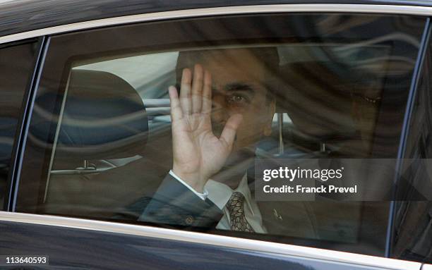 Pakistan's Prime Minister Yousouf Raza Gilani is seen through his car window waving as he leaves the Elysee palace after a meeting with French...