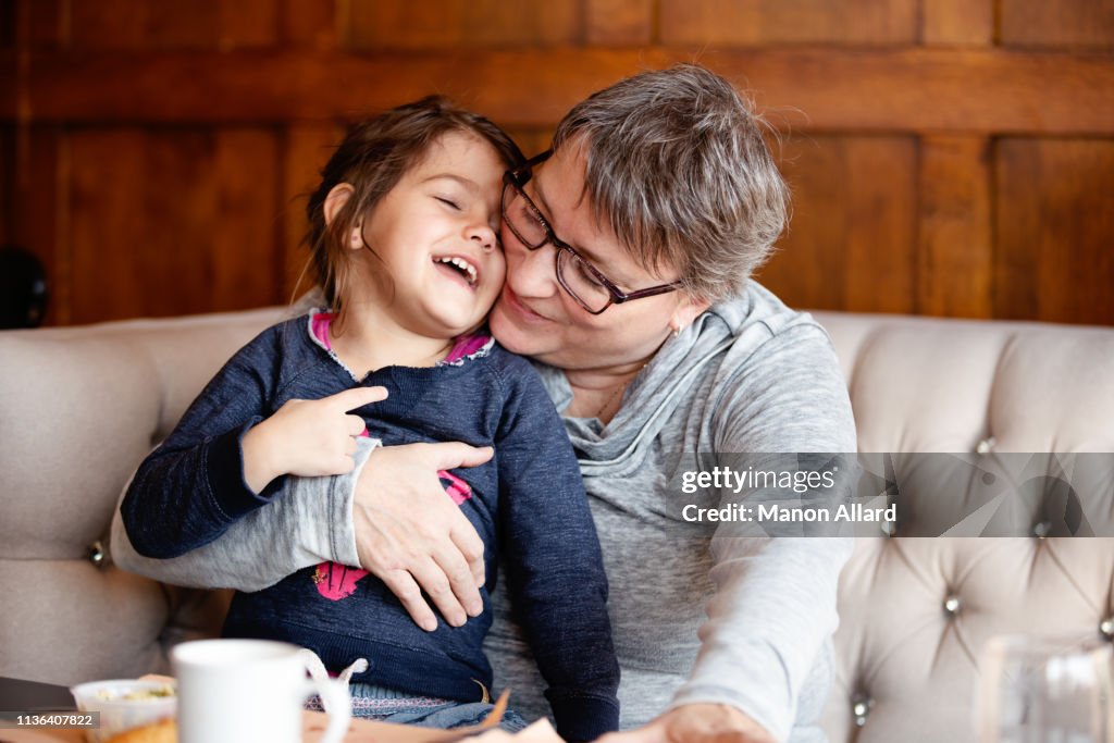 Grandmother at coffee shop with her sweet granddaughter