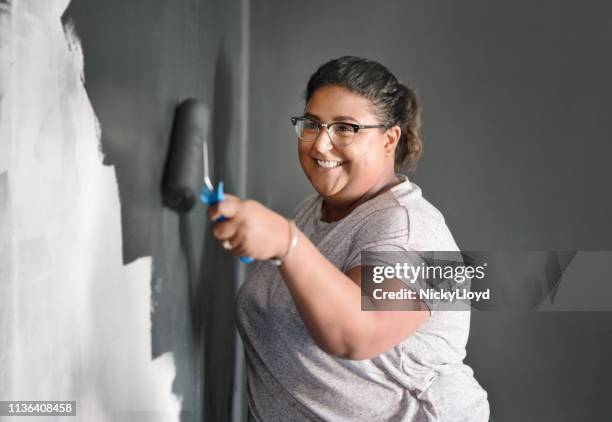 woman painting wall - paint tray stock-fotos und bilder