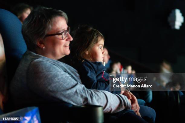 grandmother brings her granddaughter to the movies. - chubby granny foto e immagini stock