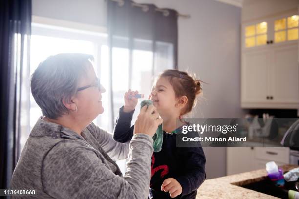 grandmother taking car of her sweet granddaughter - chubby granny foto e immagini stock