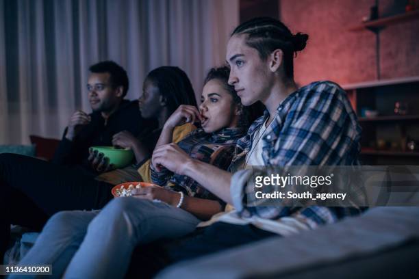 friends watching tv - college dorm party stock pictures, royalty-free photos & images