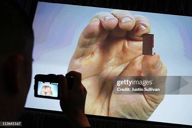 Intel Senior Fellow Mark Bohr holds a microprocessor in a video presentation during a news conference about the 3-D Tri-Gate transistors called "Ivy...