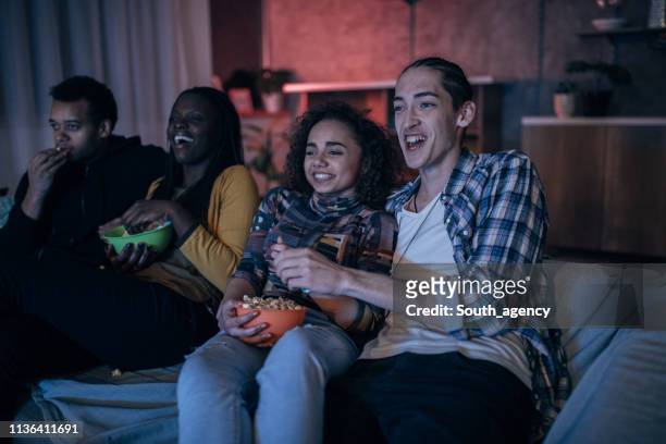 multi-ethnic friends watching tv - college dorm party stock pictures, royalty-free photos & images