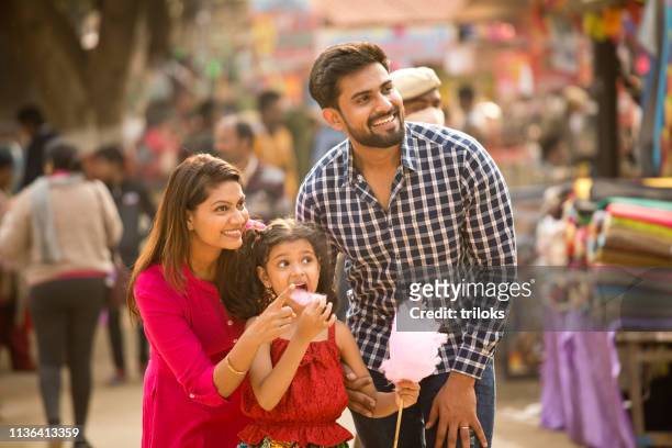 indian family at street market - indian ethnicity family stock pictures, royalty-free photos & images