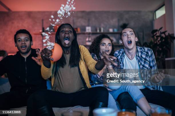 friends watching tv - college dorm party stock pictures, royalty-free photos & images