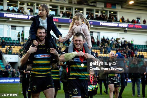 Northampton Saints players Tom Woods and Alex Waller walk around the pitch with their kids after winning the Premiership Rugby Cup Final match...