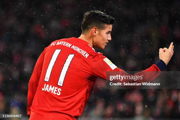 James Rodriguez of Bayern Munich celebrates his hat-trick by holding three fingers up during the Bundesliga match between FC Bayern Muenchen and 1....