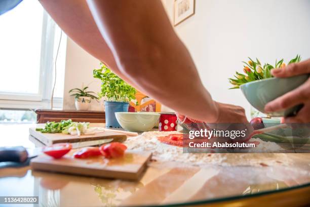 close-up of preparing vegetarian pizza at home - vegetarian pizza stock pictures, royalty-free photos & images