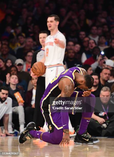 LeBron James of the Los Angeles Lakers is fouled by Mario Hezonja of the New York Knicks during the second half of the game at Madison Square Garden...