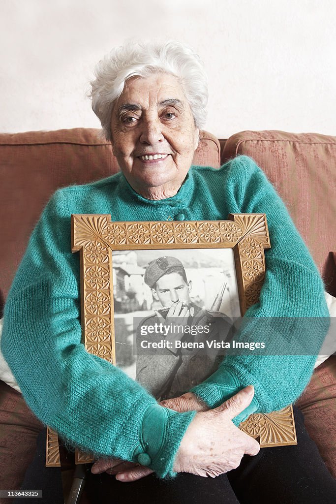 Old woman with picture of her late husband
