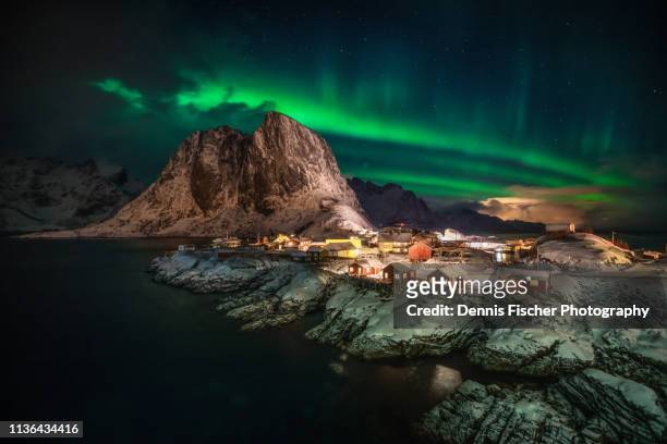 northern lights create beautiful green aurora in lofoten - aurora borealis lofoten stock-fotos und bilder