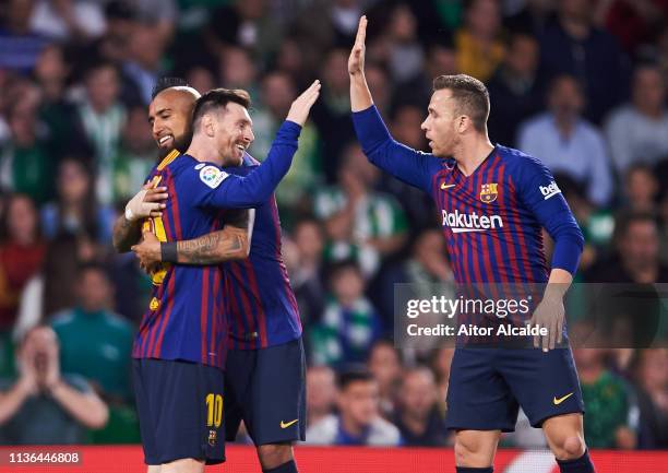 Lionel Messi of FC Barcelona celebrates with his teammates Arturo Vidal and Arthur Melo of FC Barcelona after scoring his team's second goal during...