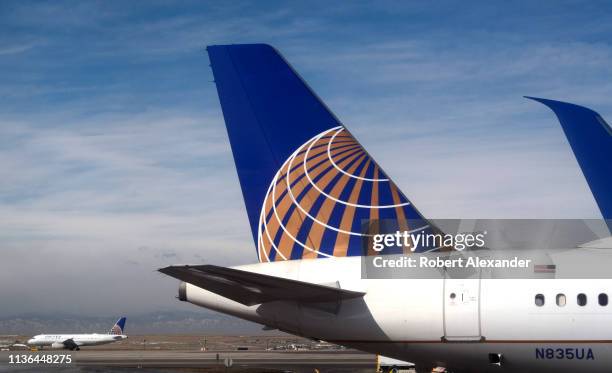 United Airlines passenger jet taxis as another is serviced at a gate at Denver International Airport in Denver, Colorado.