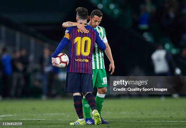 Lionel Messi of FC Barcelona and Andres Guardado of Real Betis look on after the victory of the La Liga match between Real Betis Balompie and FC...