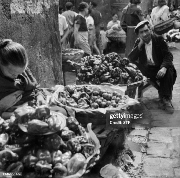 People sell vegetables on a market in Barcelona in April 1949.