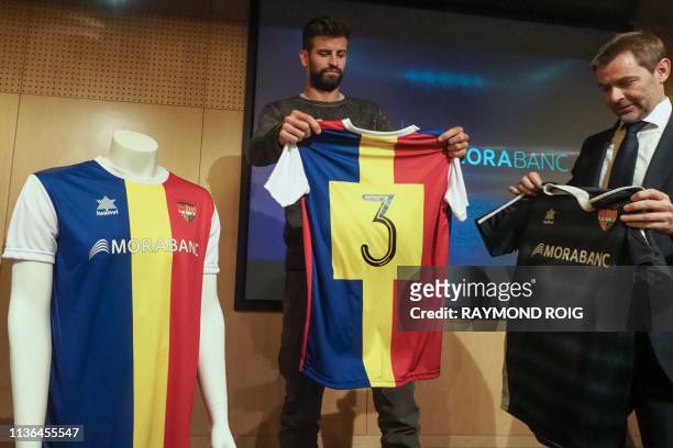 Barcelona Spanish defender and Kosmos investment company president Gerard Pique and general director of MoraBanc financial group Lluis Alsina hold FC...
