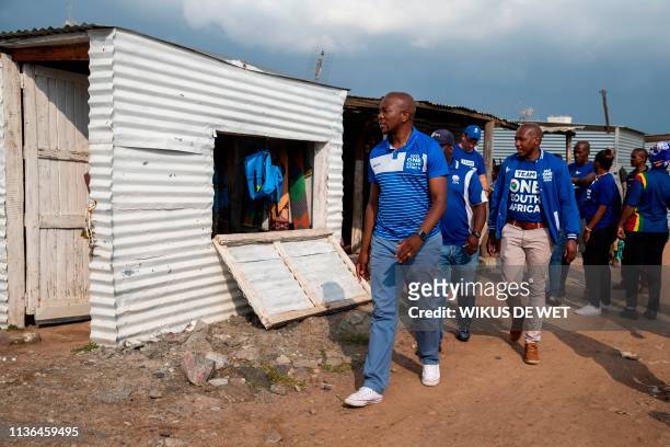 South Africa's main opposition Democratic Alliance leader Mmusi Maimane walks in the Marikana community as part his election campaign trail ahead of...