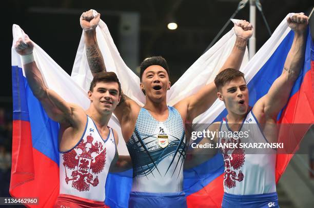 Russia's Artur Dalaloyan, Cyprus' Marios Georgiou and Russia's Nikita Nagornyy celebrate after the Men's All-Around final during the Artistic...